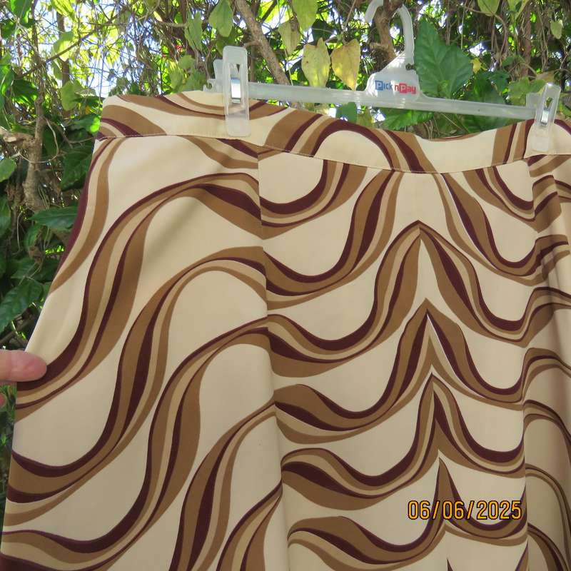 Graphic printed rich cream fully lined polyester A-Line skirt. Brown-tan print. Size 50