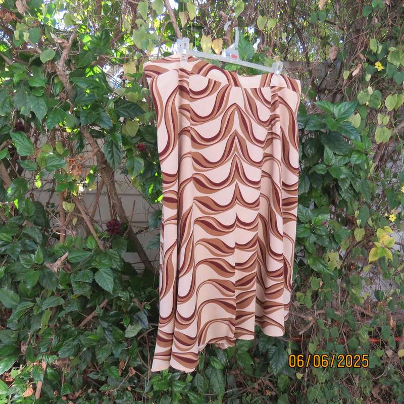 Graphic printed rich cream fully lined polyester A-Line skirt. Brown-tan print. Size 50