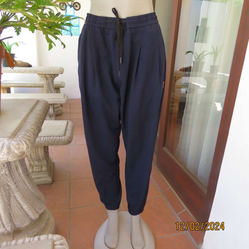 Comfy wide cut navy polyester pants size 38. Front pleats.Elasticated waist -leg hems. Drawstring.