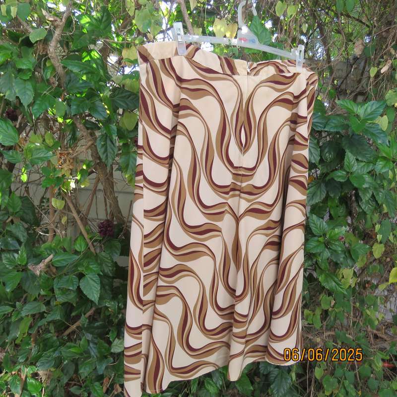 Graphic printed rich cream fully lined polyester A-Line skirt. Brown-tan print. Size 50