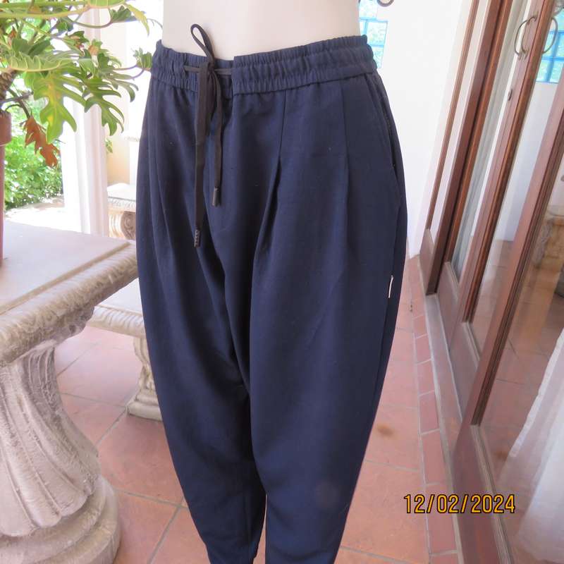 Comfy wide cut navy polyester pants size 38. Front pleats.Elasticated waist -leg hems. Drawstring.