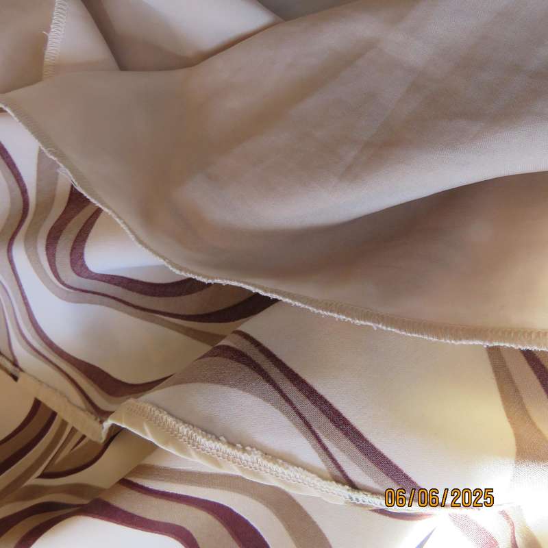Graphic printed rich cream fully lined polyester A-Line skirt. Brown-tan print. Size 50