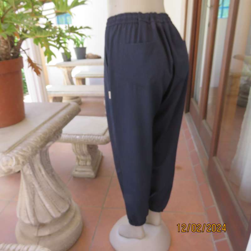 Comfy wide cut navy polyester pants size 38. Front pleats.Elasticated waist -leg hems. Drawstring.