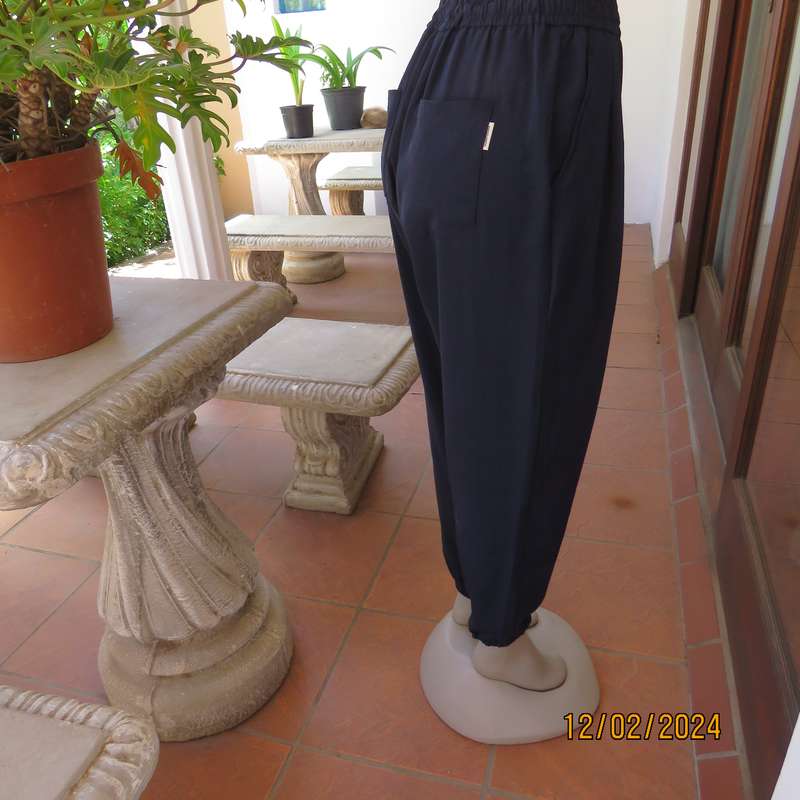 Comfy wide cut navy polyester pants size 38. Front pleats.Elasticated waist -leg hems. Drawstring.