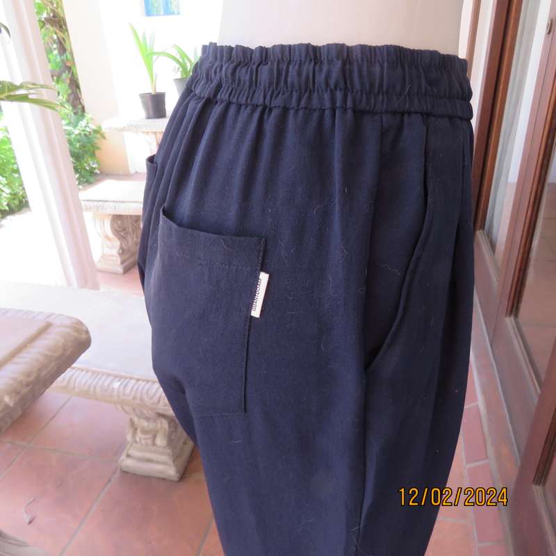 Comfy wide cut navy polyester pants size 38. Front pleats.Elasticated waist -leg hems. Drawstring.