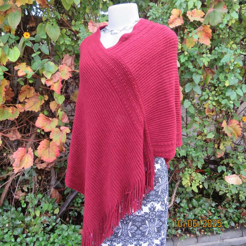 Maroon acrylic knit poncho partly fringed to fit size 32 to 36.