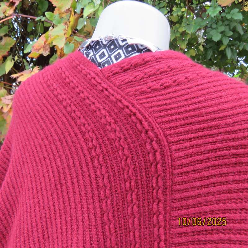 Maroon acrylic knit poncho partly fringed to fit size 32 to 36.