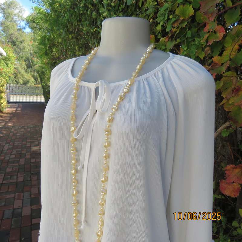FASHION EXPRESS long raglan sleeve top in woven chiffon. Size 36-38. Lace sleeve cuffs.