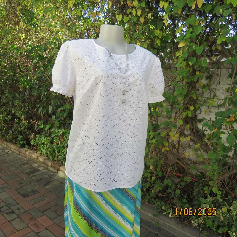 White cotton slip over top. Front and sleeves with eyelet embroidery. Size 36