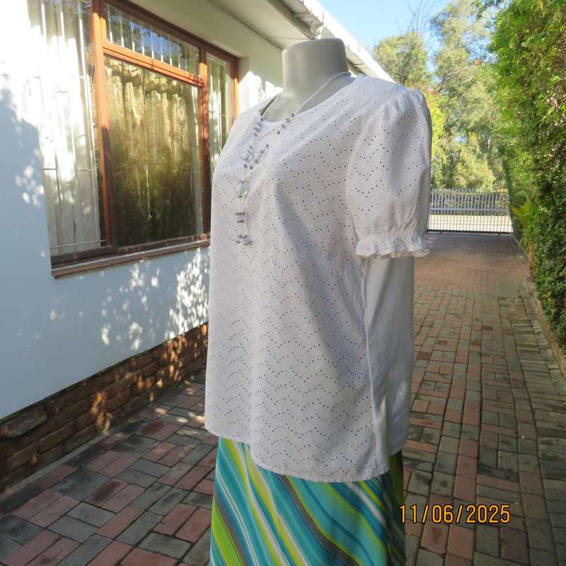 White cotton slip over top. Front and sleeves with eyelet embroidery. Size 36