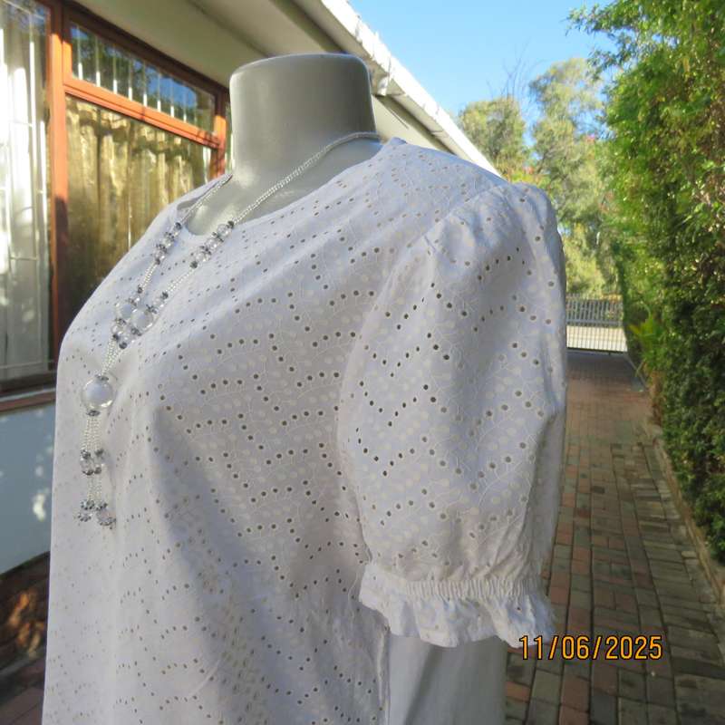 White cotton slip over top. Front and sleeves with eyelet embroidery. Size 36
