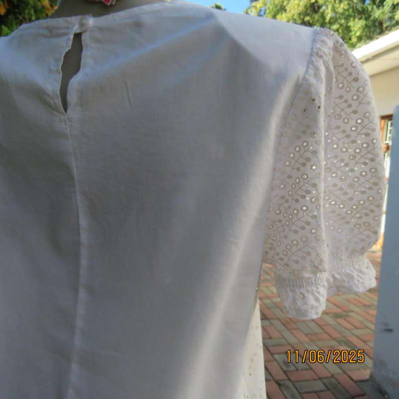 White cotton slip over top. Front and sleeves with eyelet embroidery. Size 36