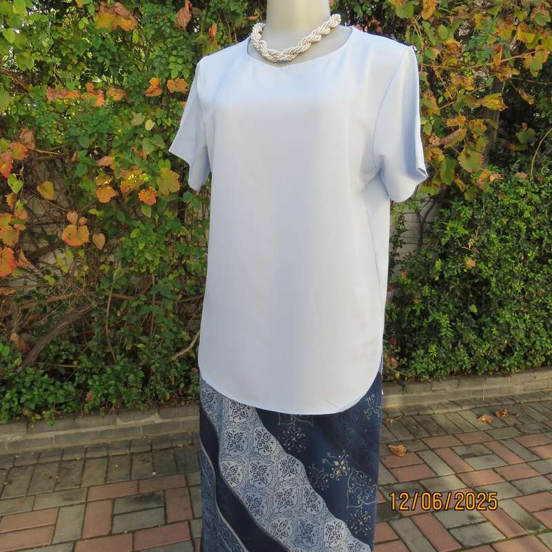 Light blue textured polyester slip over short sleeve top. Size 34. As new