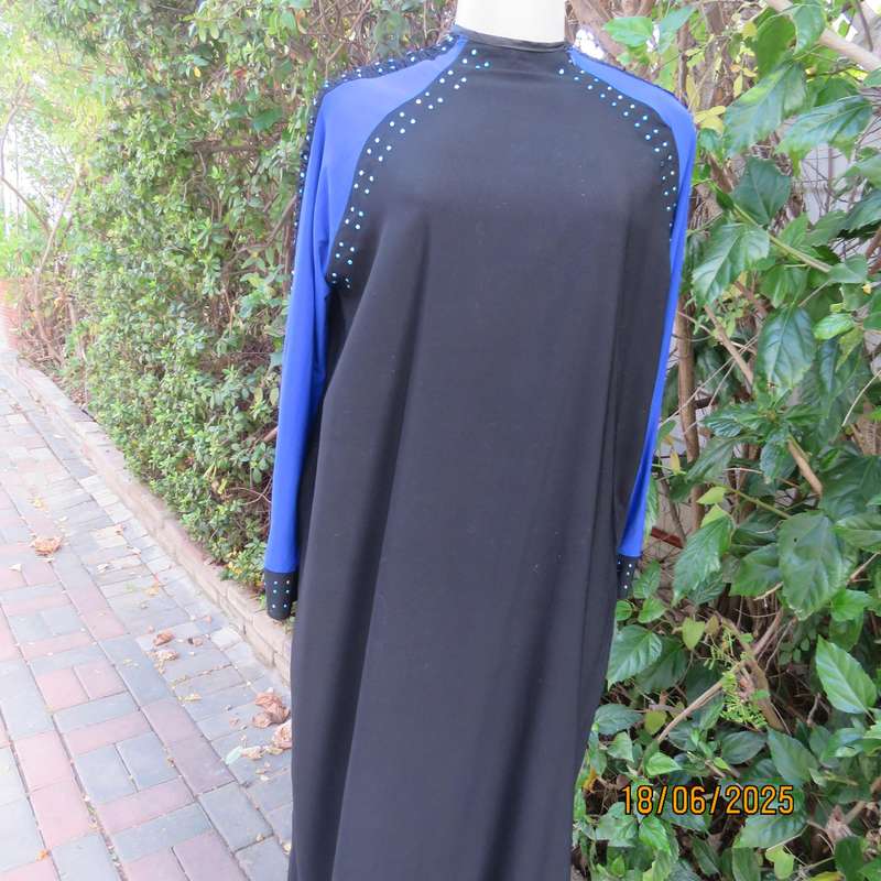 Black long sleeve polyester-rayon floor length dress. Blue inlays. Size 40