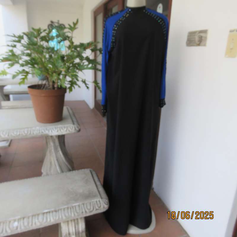 Black long sleeve polyester-rayon floor length dress. Blue inlays. Size 40