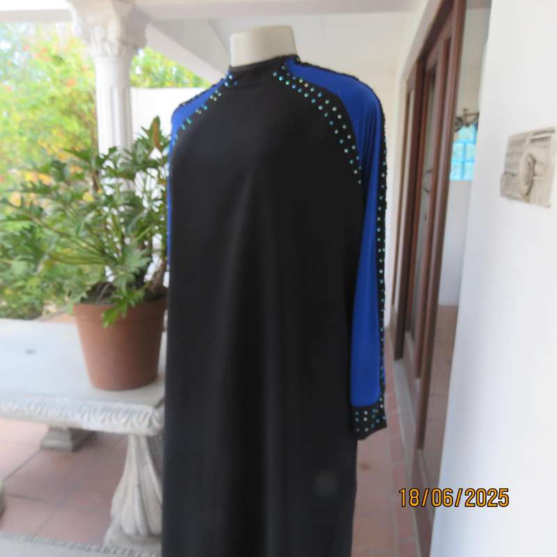 Black long sleeve polyester-rayon floor length dress. Blue inlays. Size 40