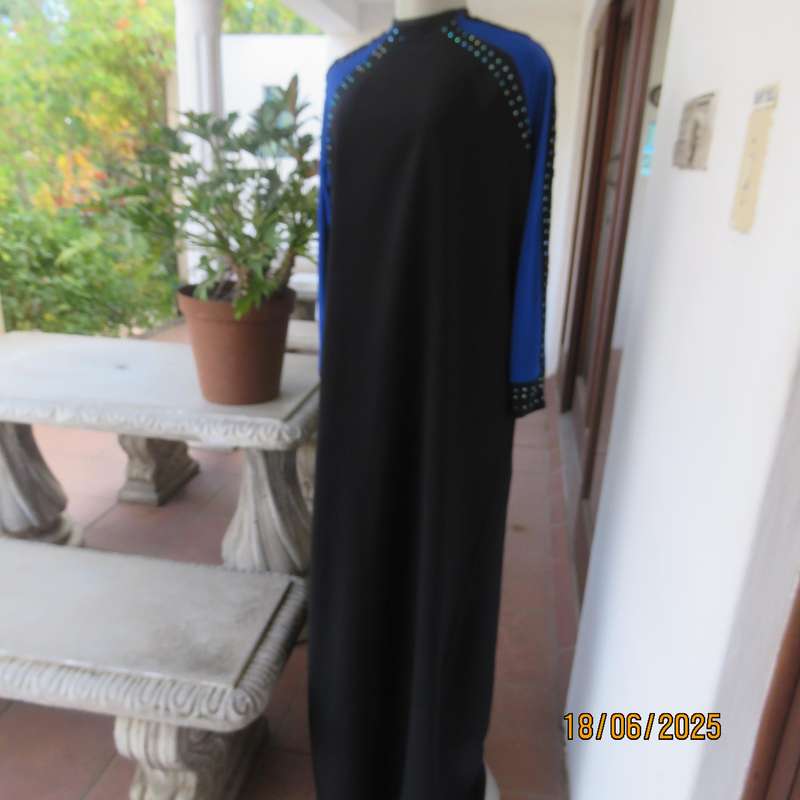 Black long sleeve polyester-rayon floor length dress. Blue inlays. Size 40