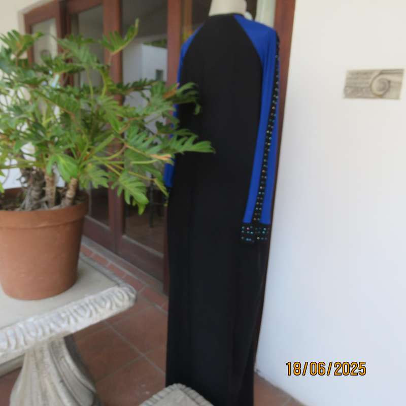Black long sleeve polyester-rayon floor length dress. Blue inlays. Size 40