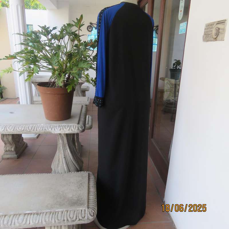 Black long sleeve polyester-rayon floor length dress. Blue inlays. Size 40