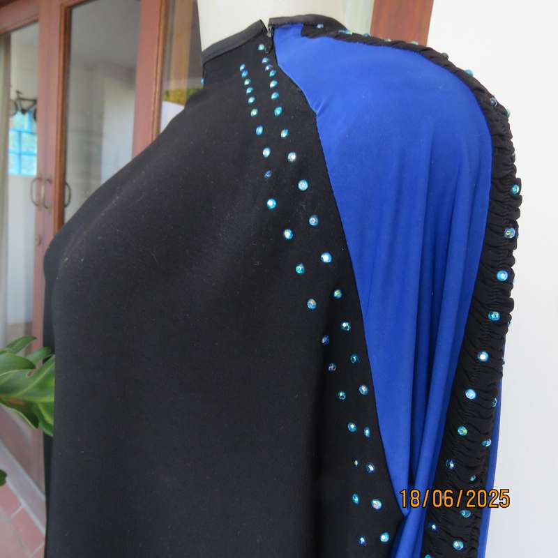 Black long sleeve polyester-rayon floor length dress. Blue inlays. Size 40