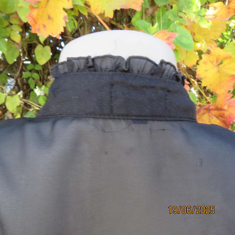 NOSTALGIA sheer black polyester peplum size 37 top. Halfway button down.