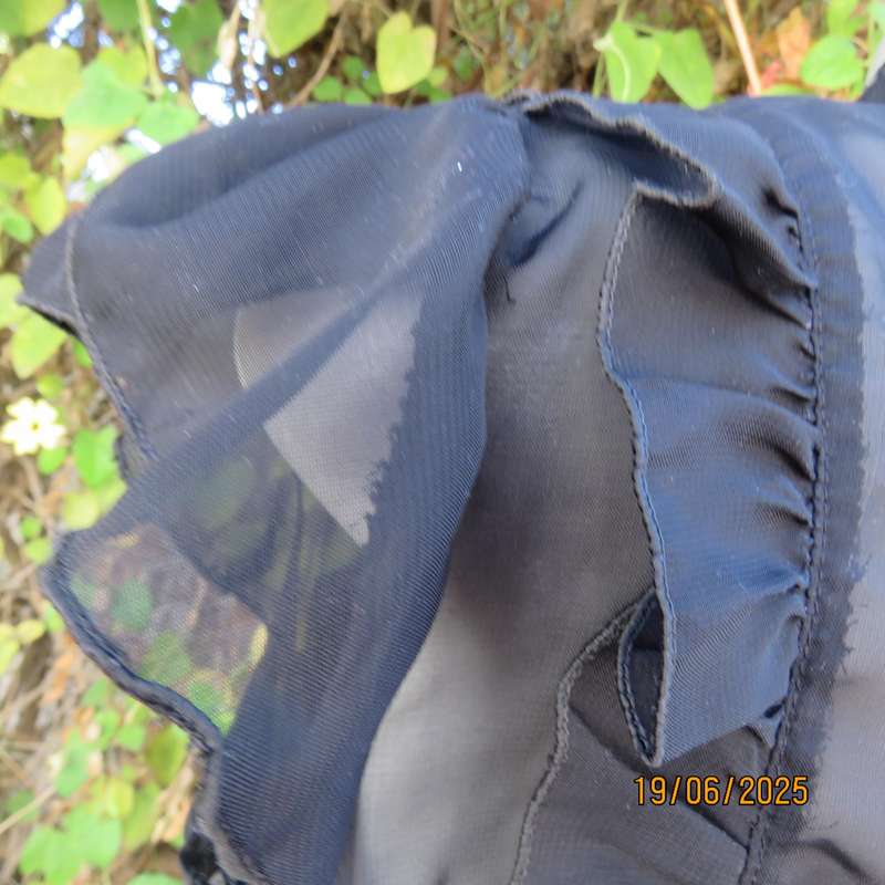 NOSTALGIA sheer black polyester peplum size 37 top. Halfway button down.