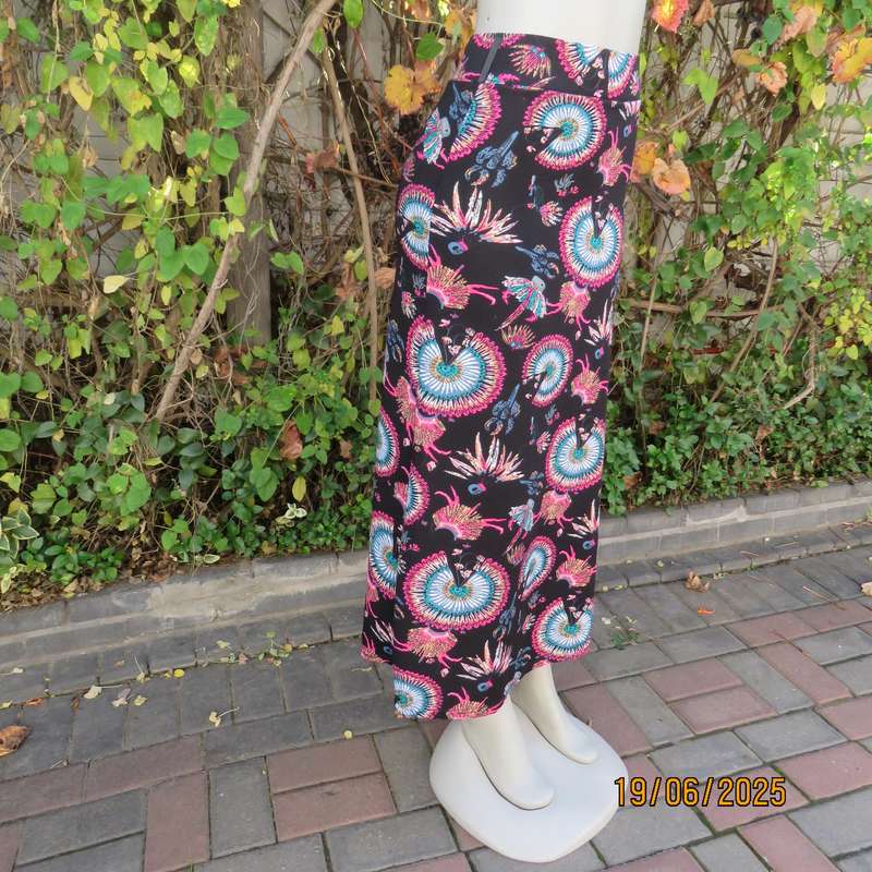 Black ankle length stretch polyester A-line skirt with pink-blue designs. Size 32