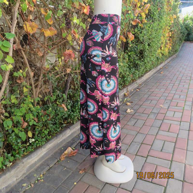 Black ankle length stretch polyester A-line skirt with pink-blue designs. Size 32