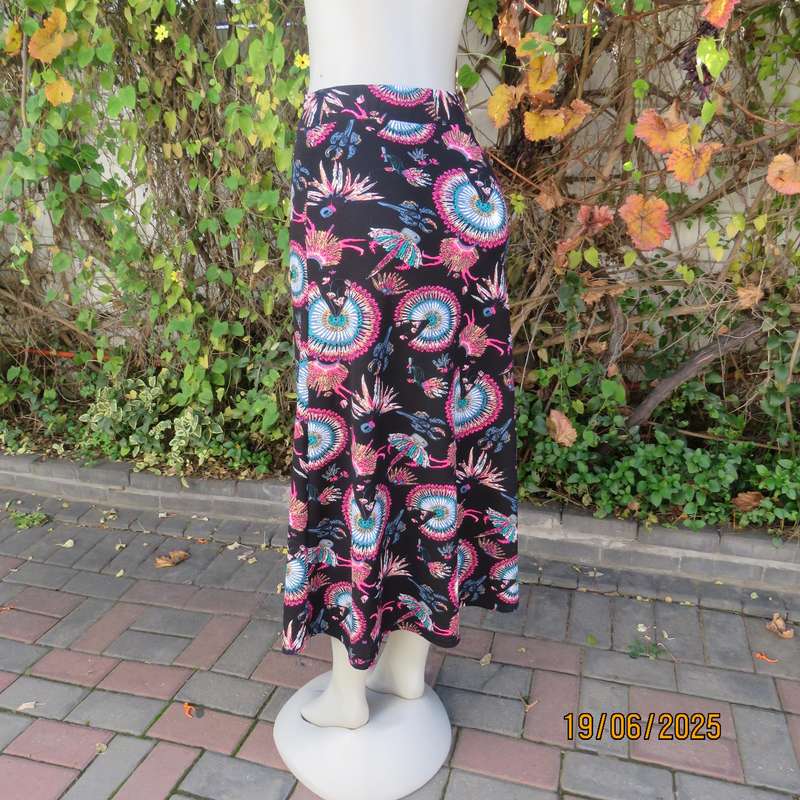 Black ankle length stretch polyester A-line skirt with pink-blue designs. Size 32
