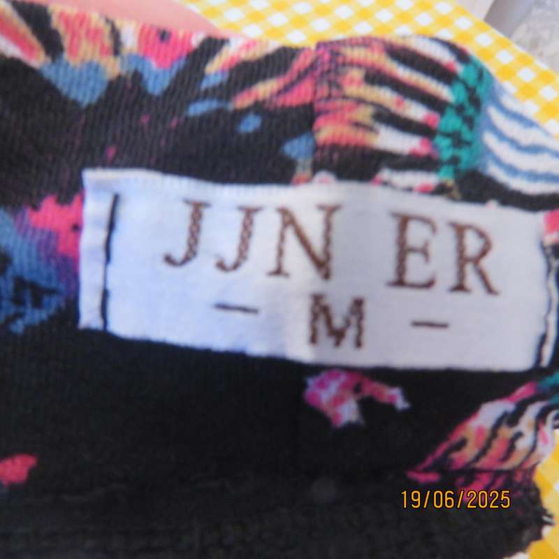 Black ankle length stretch polyester A-line skirt with pink-blue designs. Size 32