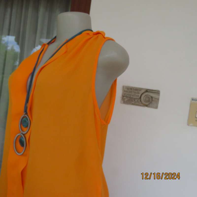Tangerine cool slip over polyester V front top. Gathered front shoulders. Longer back.Slits.Size 36.
