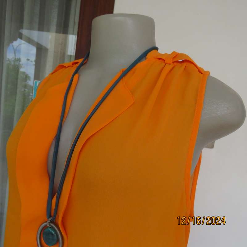 Tangerine cool slip over polyester V front top. Gathered front shoulders. Longer back.Slits.Size 36.