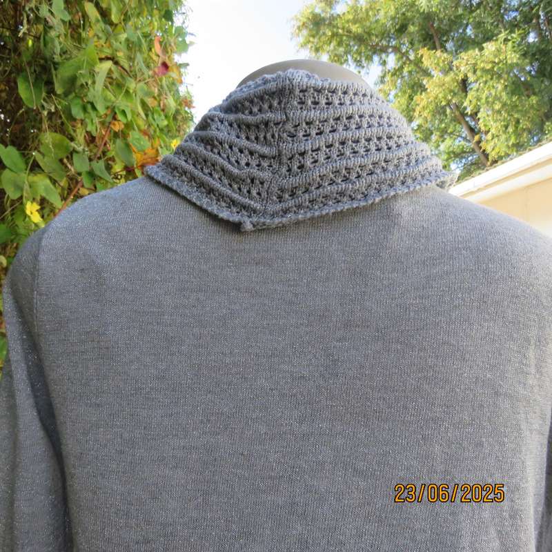 Silver open front polyester-lurex knit cover up size 30. Loose knit al around collar.
