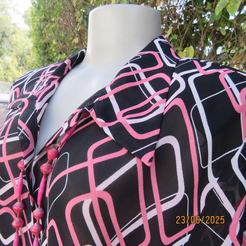 ANNA PIA black sheer polyester sheer polyester top with pink-white link print. Size large 44