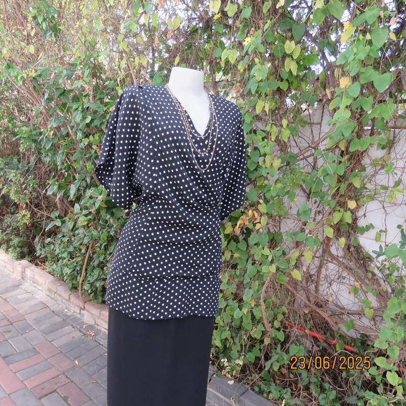 Boutique made black silky polyester top with white polkadots. Size 48. Fold over neckline.