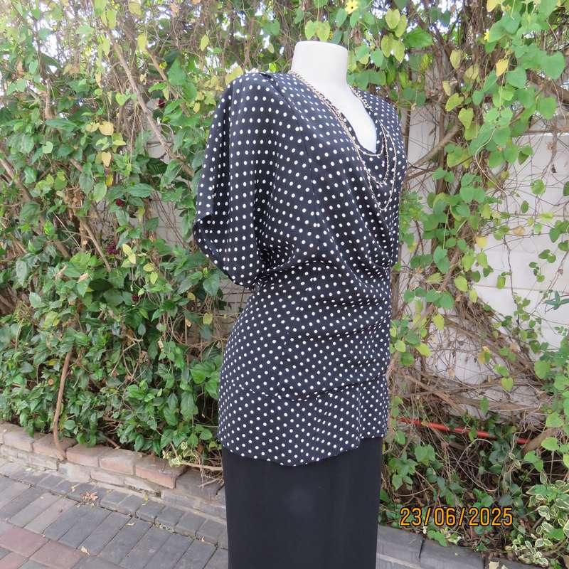 Boutique made black silky polyester top with white polkadots. Size 48. Fold over neckline.