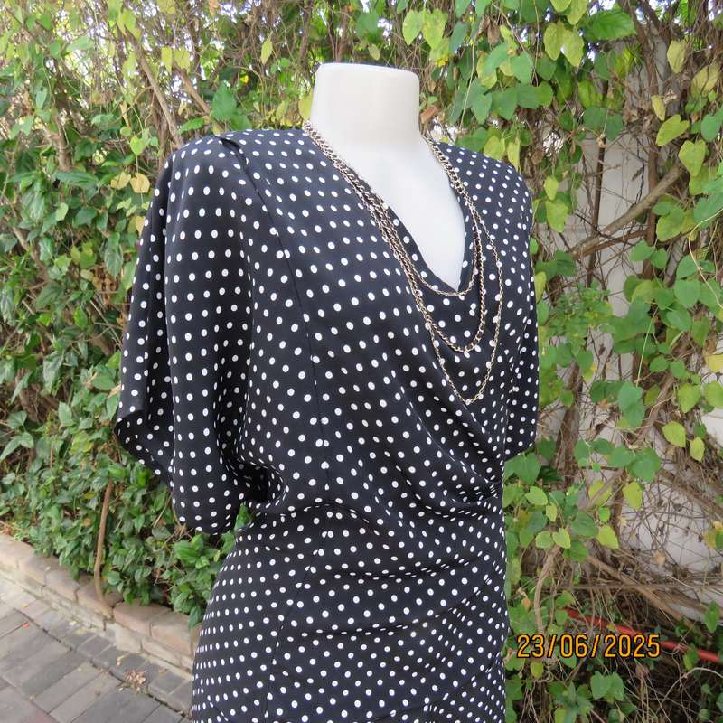 Boutique made black silky polyester top with white polkadots. Size 48. Fold over neckline.