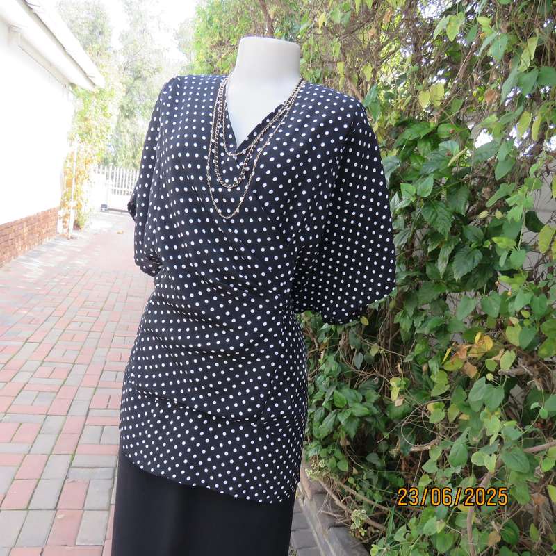 Boutique made black silky polyester top with white polkadots. Size 48. Fold over neckline.