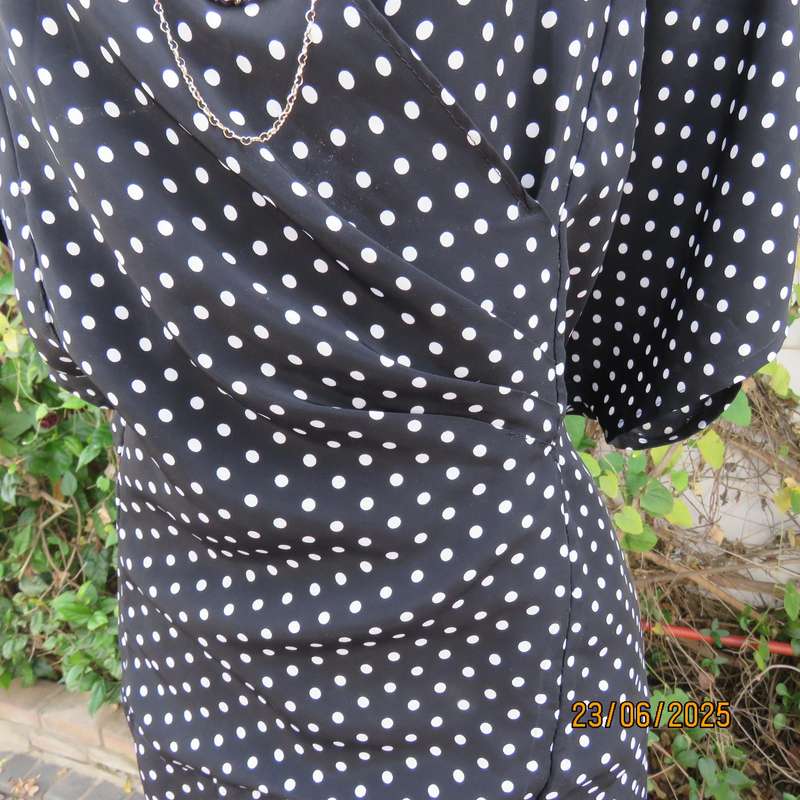 Boutique made black silky polyester top with white polkadots. Size 48. Fold over neckline.
