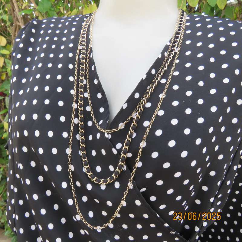 Boutique made black silky polyester top with white polkadots. Size 48. Fold over neckline.