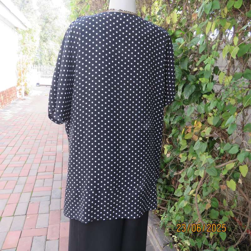 Boutique made black silky polyester top with white polkadots. Size 48. Fold over neckline.