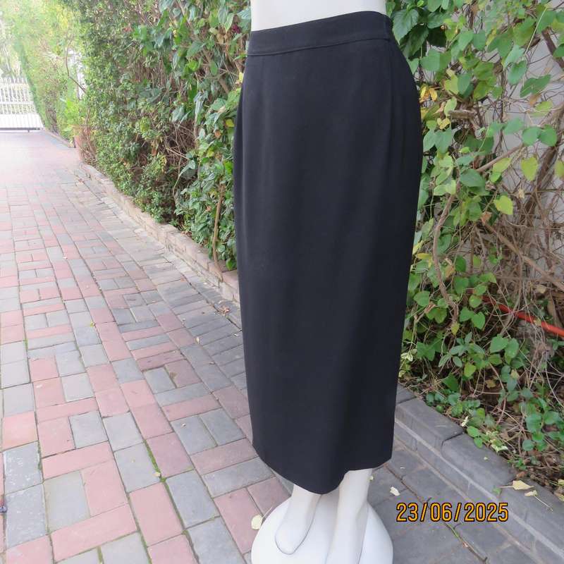 Very black lined ankle length polyester pencil skirt. Size 44 loose fit. Elasticated sides.