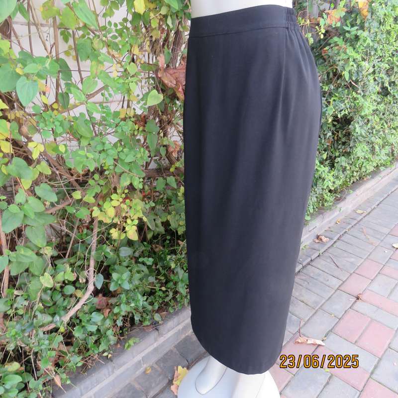 Very black lined ankle length polyester pencil skirt. Size 44 loose fit. Elasticated sides.