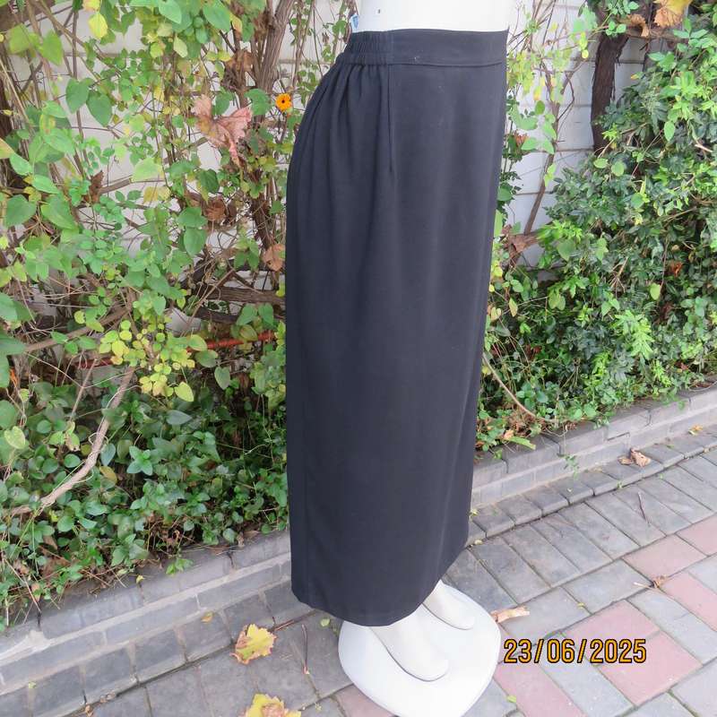 Very black lined ankle length polyester pencil skirt. Size 44 loose fit. Elasticated sides.