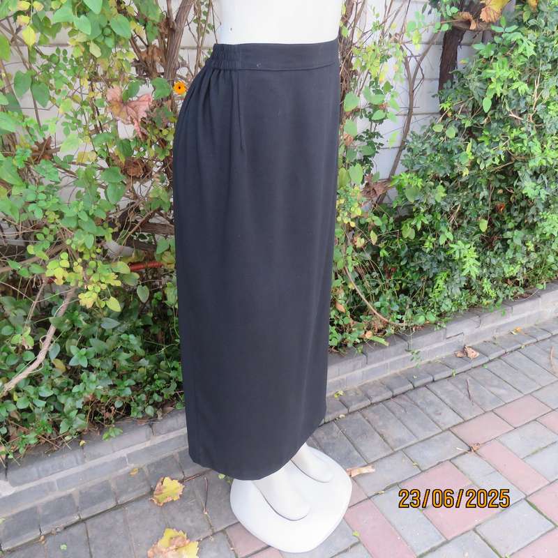 Very black lined ankle length polyester pencil skirt. Size 44 loose fit. Elasticated sides.