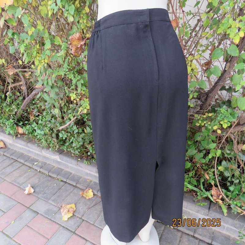 Very black lined ankle length polyester pencil skirt. Size 44 loose fit. Elasticated sides.