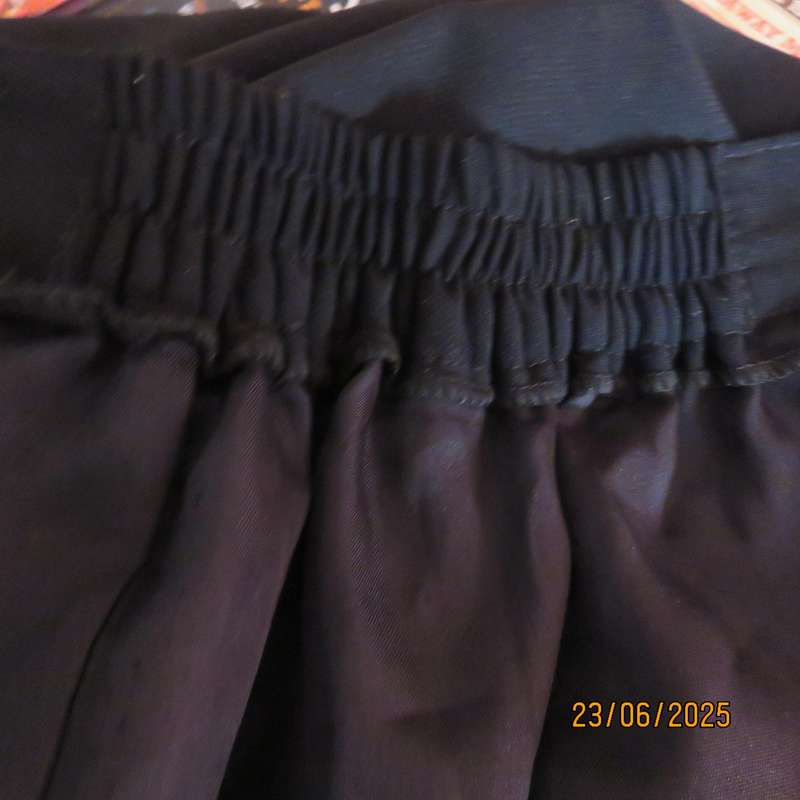 Very black lined ankle length polyester pencil skirt. Size 44 loose fit. Elasticated sides.