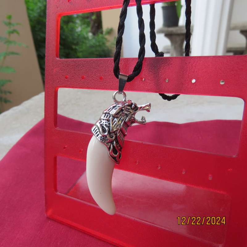 Faux ivory tooth pendant in stainless steel with black cord for men.