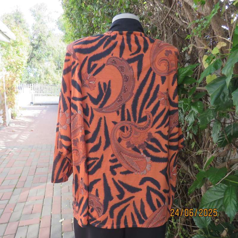 Burnt orange-black bohemian print long open front top. Kimono style sleeves. Size 44