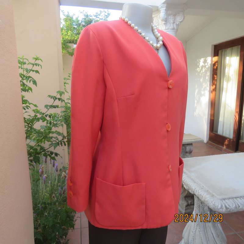 Stunning boutique made papaya colour long sleeve lined collarless jacket.Size 38.Poly-viscose blend.
